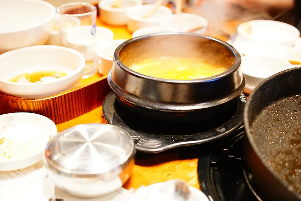A large stone pot of doenjang jjigae