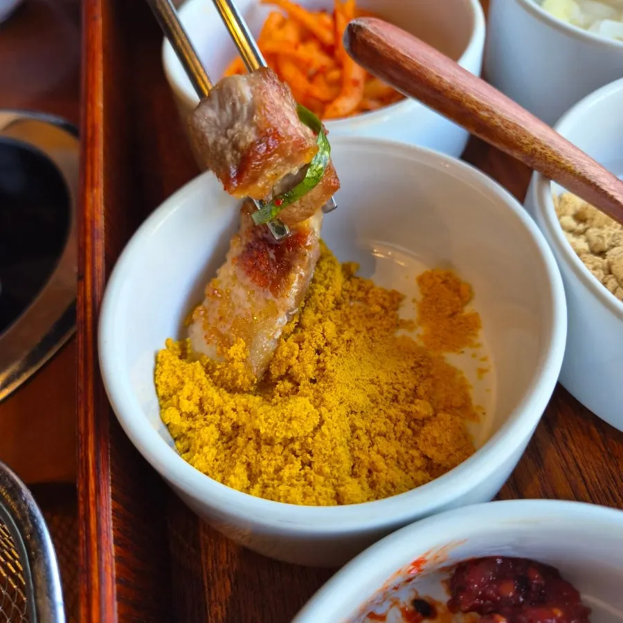 Pork belly dipped into melchot sauce