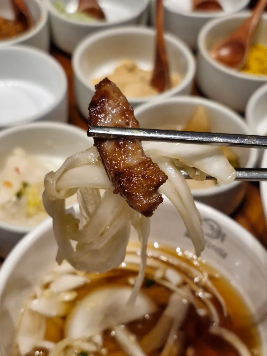 Mustard leaf kimchi and onion sauce on the grill plate
