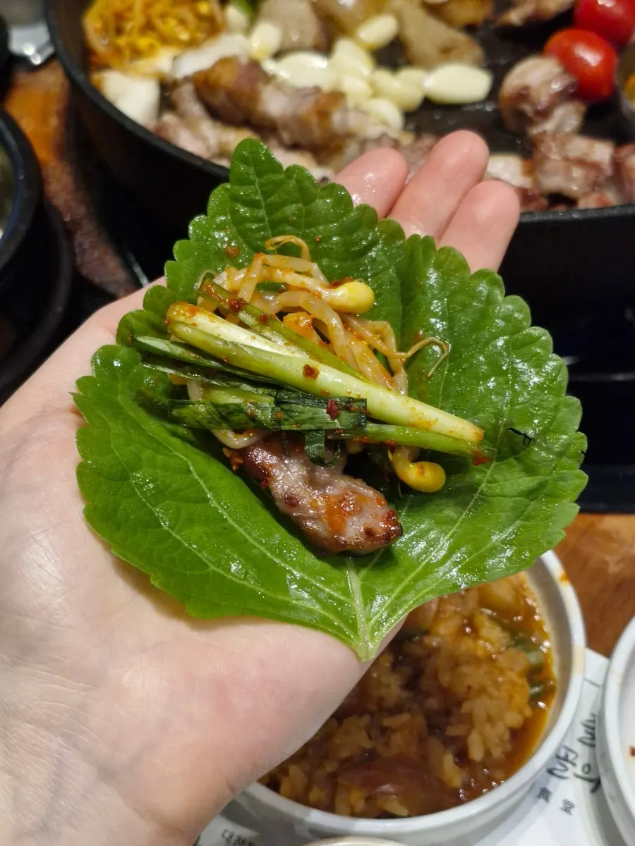Lettuce wrap loaded with meat and side dishes