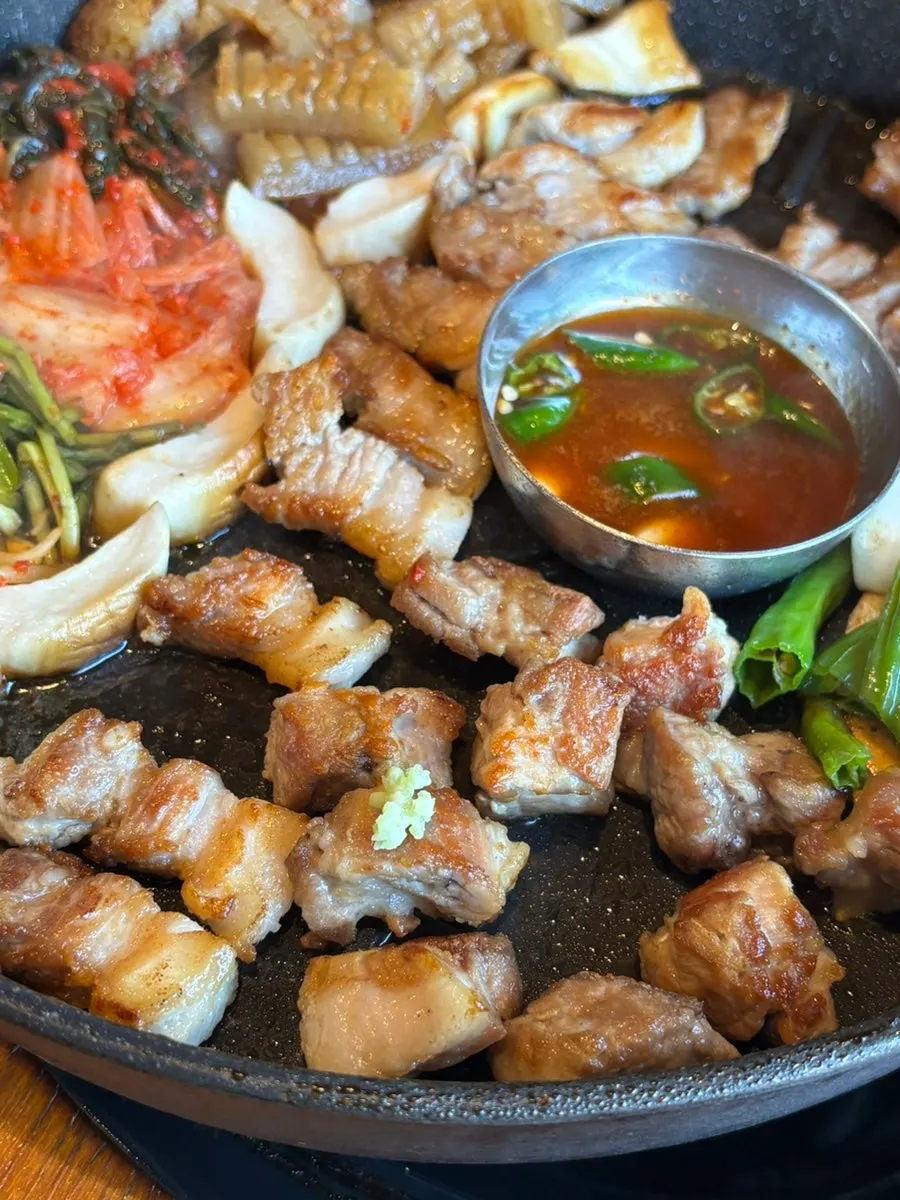 A piece of pork neck topped with wasabi