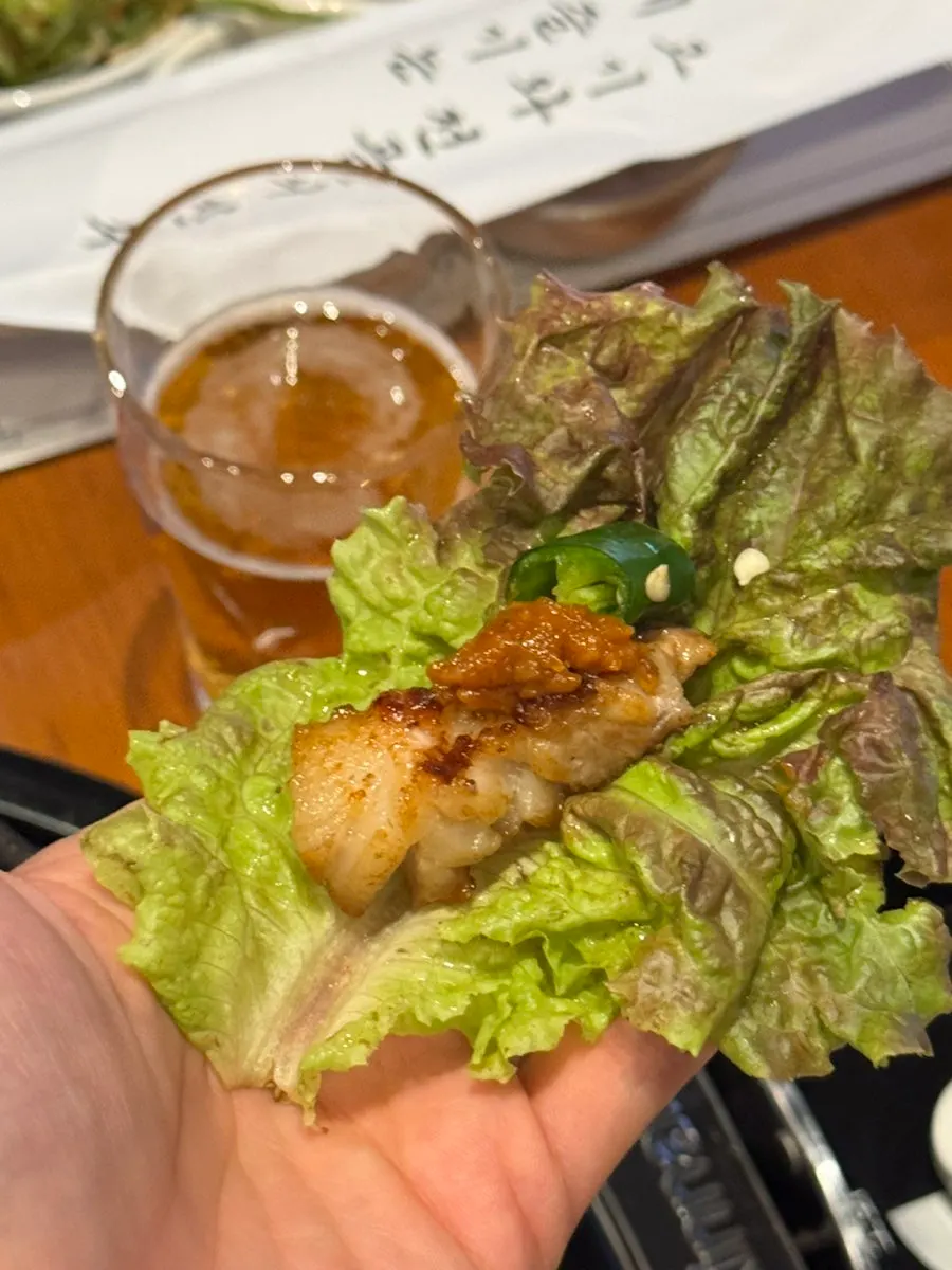 Pork belly grilling on the griddle with garnish