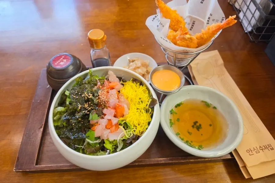 Table with sushi and side dishes laid out together