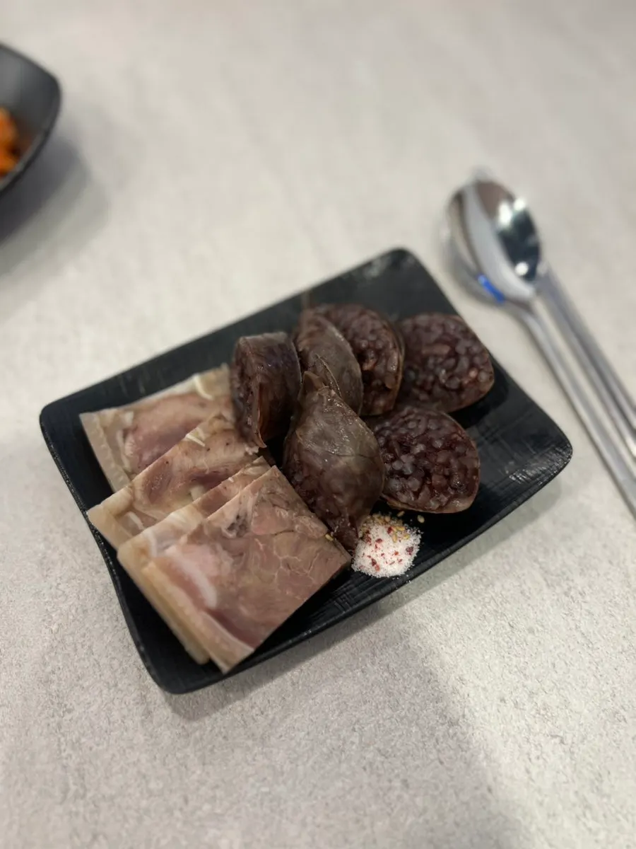 Plate of pork slices and rice sausage from the set