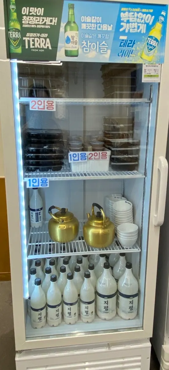 Self-serve bar with kimchi, vegetables, and noodle sides