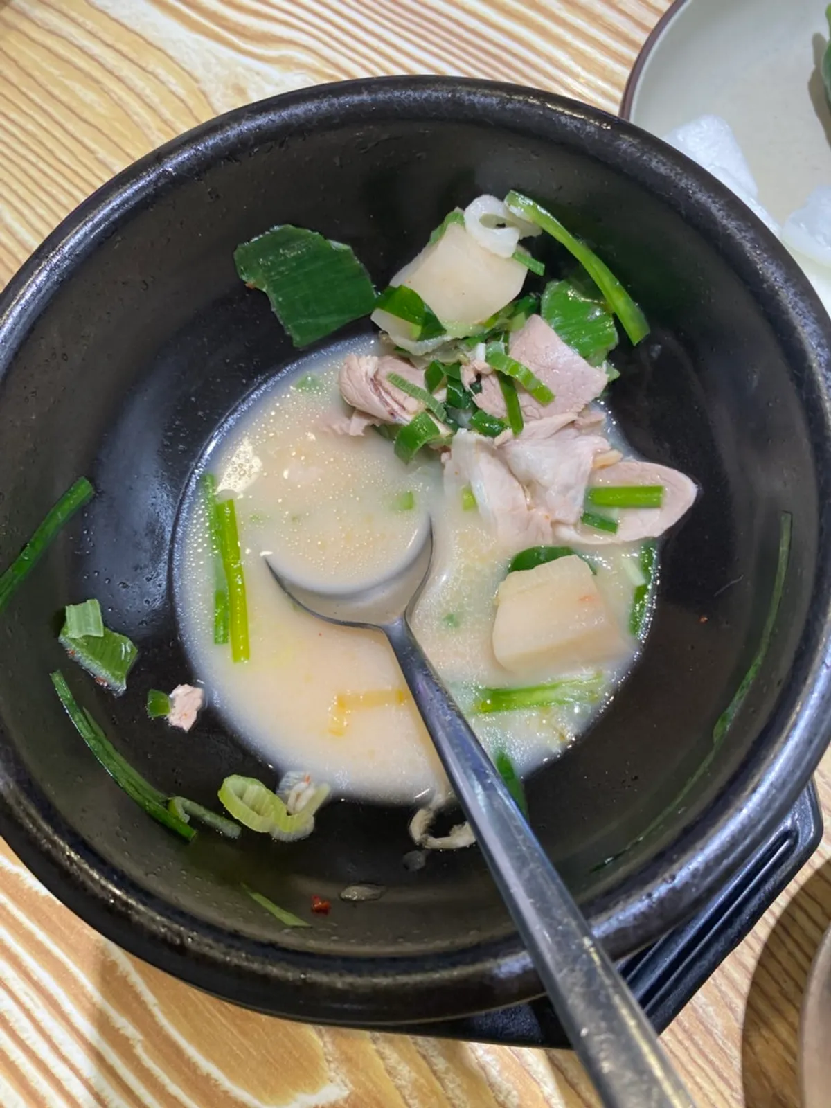 A refilled hot stone bowl of pork soup
