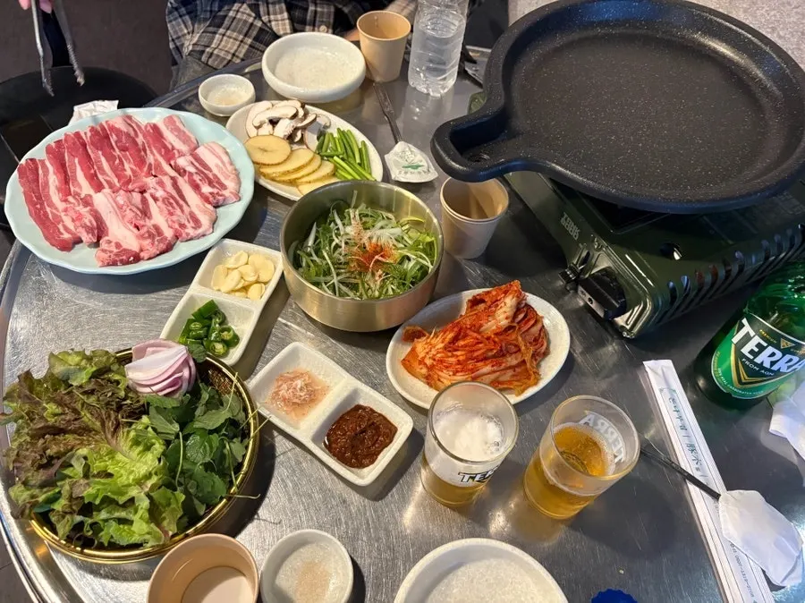 Basic side dish spread with lettuce, perilla, kimchi and scallion salad