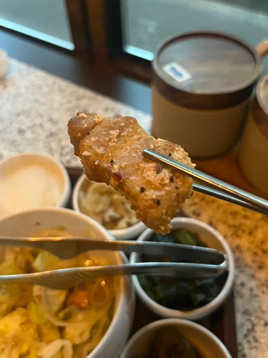 A bite of meat topped with extra wasabi