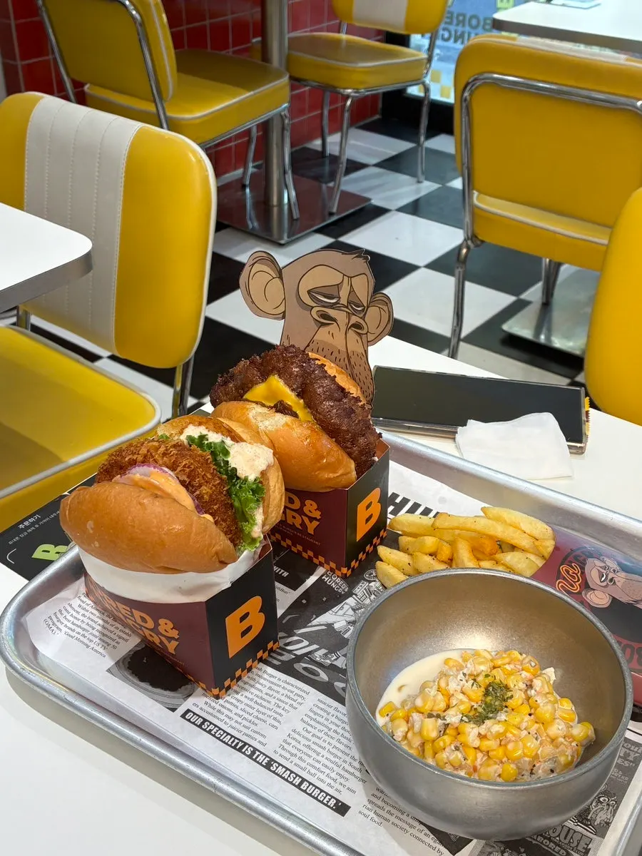 Table set with burgers and sides