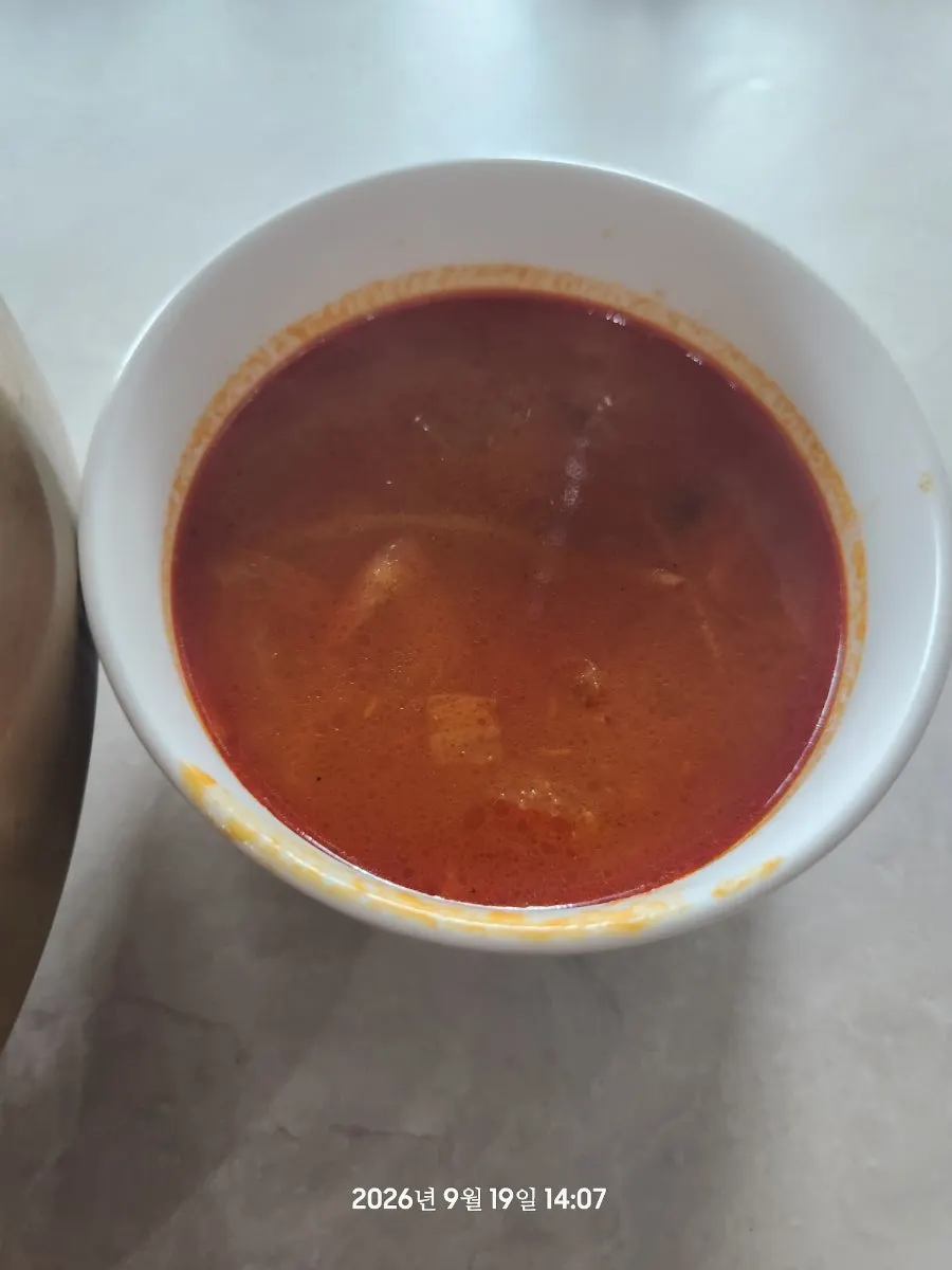 Jjamppong broth served alongside the junghwa bibimbap