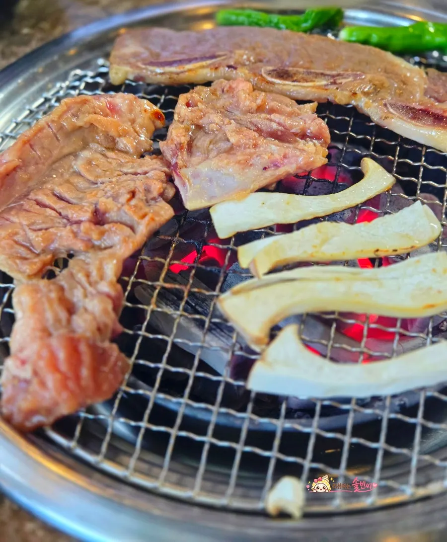 Seasoned pork galbi grilling over charcoal at Gyesu Garden