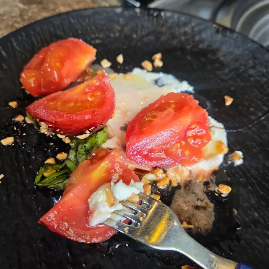 A plate of whole tomato ricotta cheese salad