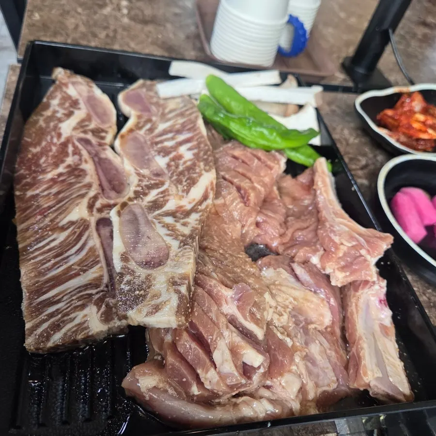 Pork galbi and LA galbi served together on a plate