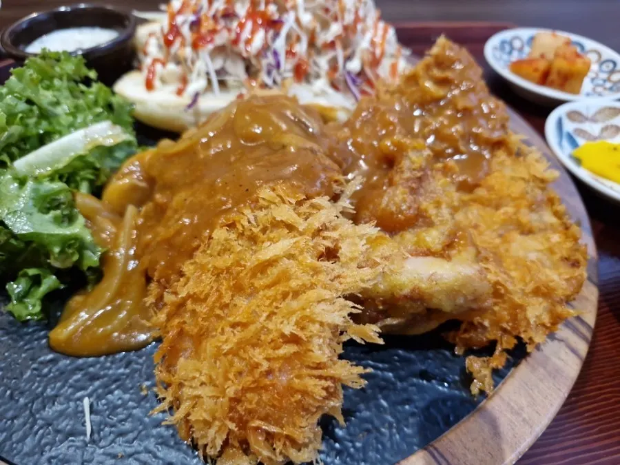Plate with crispy main fried dish and salad