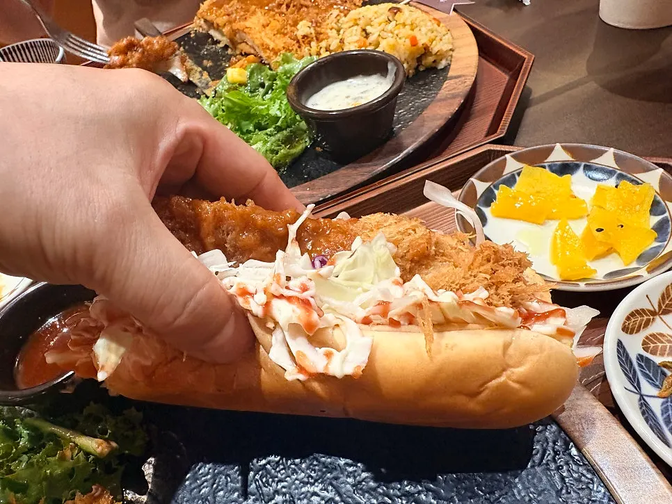 A cross-section of the thick chicken cutlet showing crispy batter