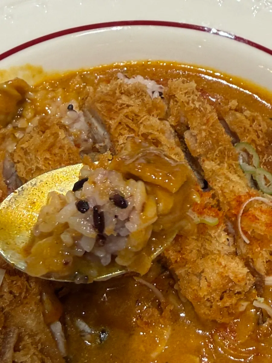 A moist bite of pork cutlet curry with curry sauce