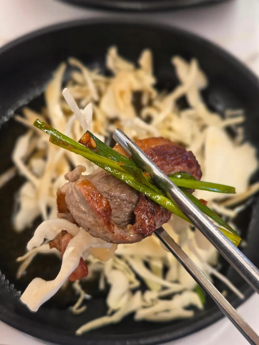 Duck on cabbage topped with chive salad