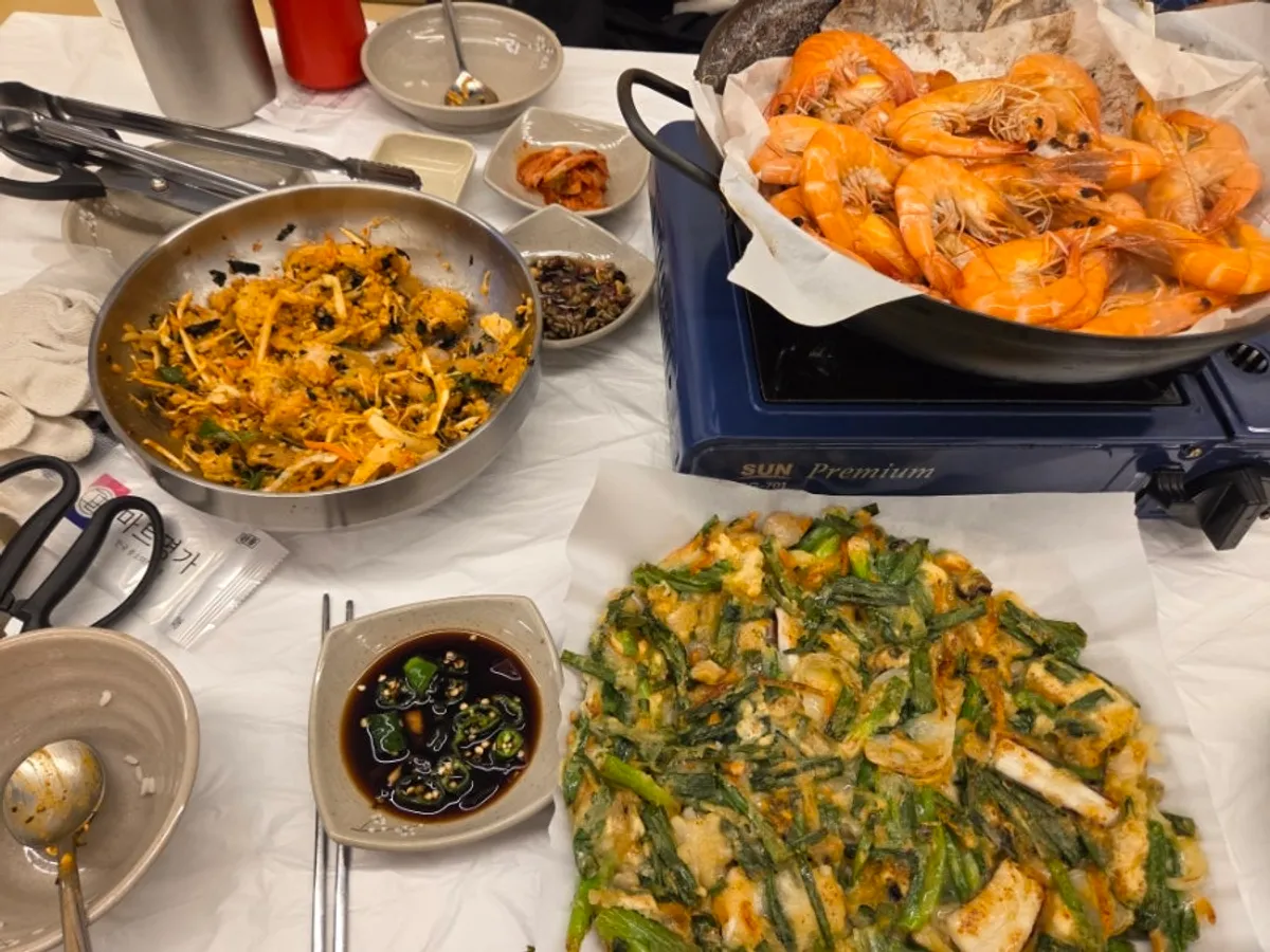 Butter-grilled prawn heads next to grilled prawns