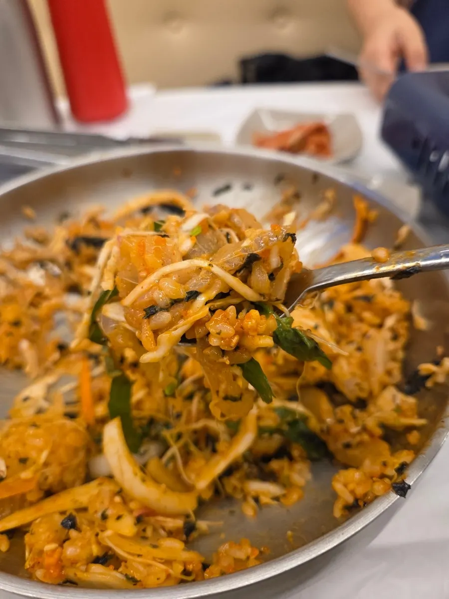 A spoonful of the mixed raw fish rice bowl