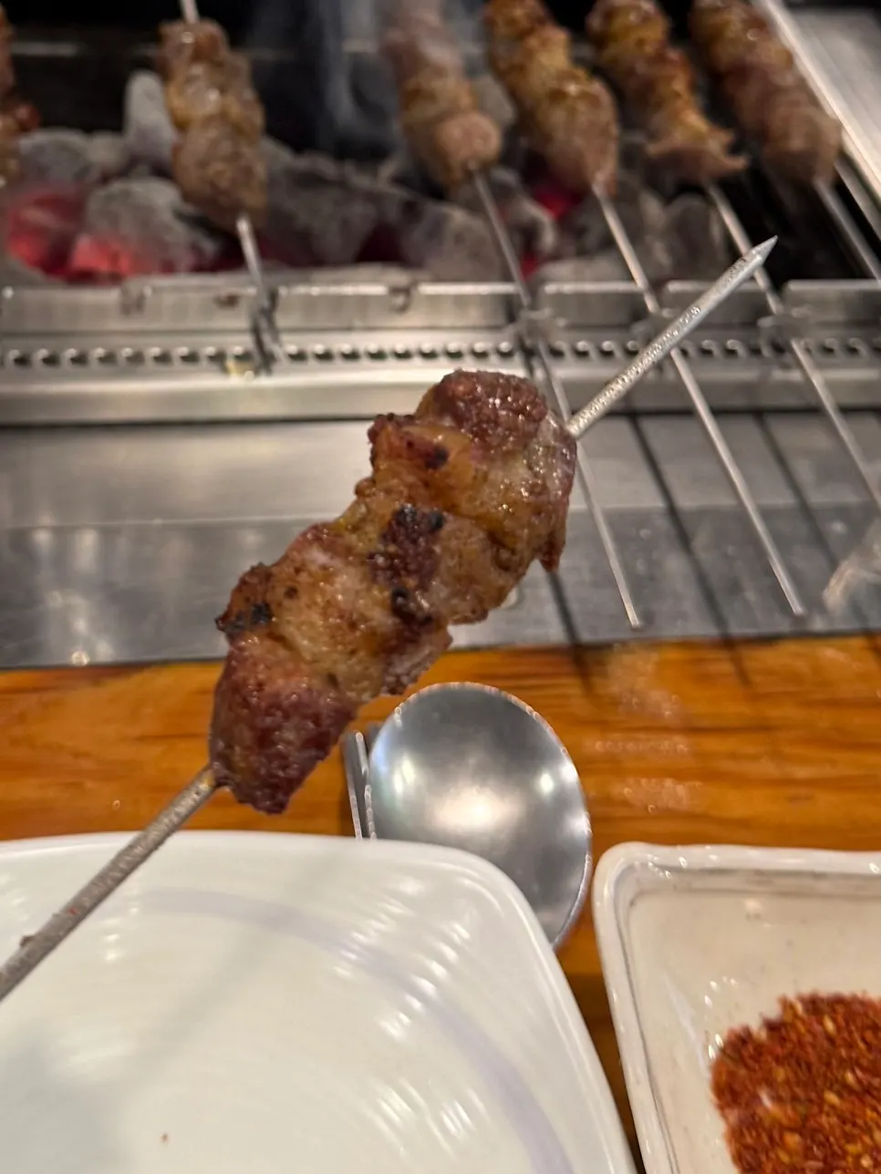 Lamb skewers grilled at the table