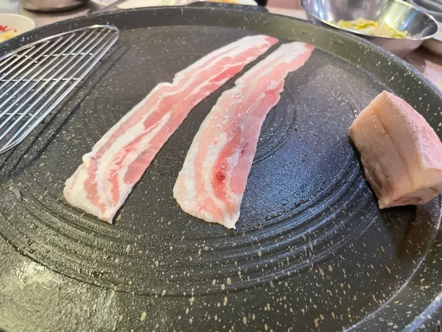 Two portions of chilled Korean thin-sliced pork belly