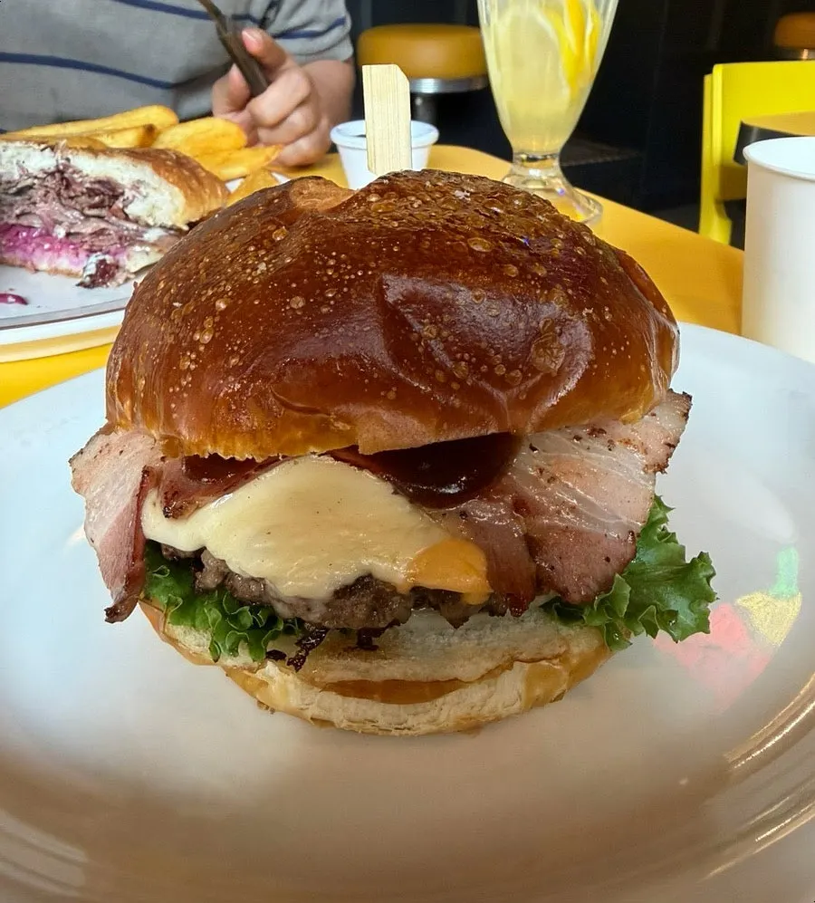 Hawaiian bacon BBQ burger with pretzel bun and added swiss cheese