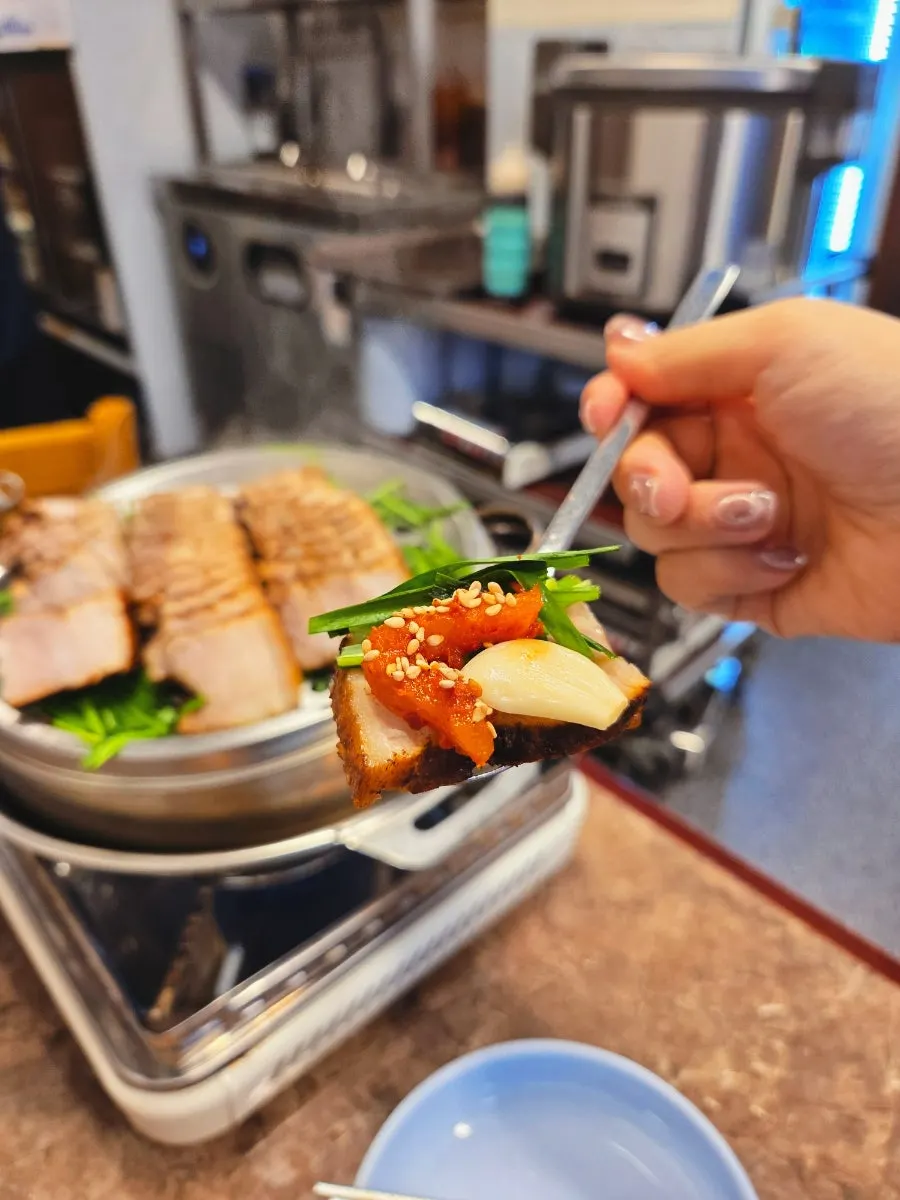 Kimchi and radish served alongside the boiled pork bossam