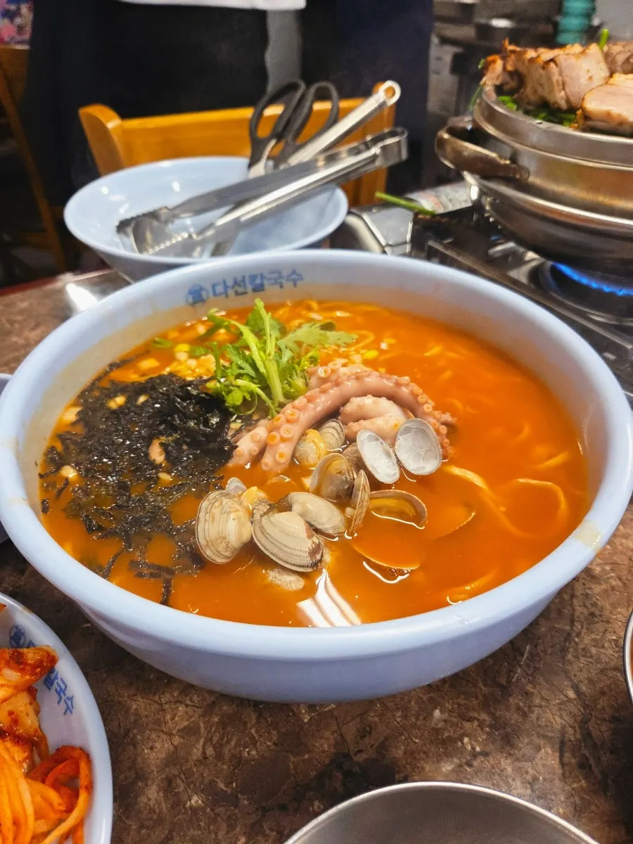 Spicy octopus kalguksu for two, filled with octopus and clams