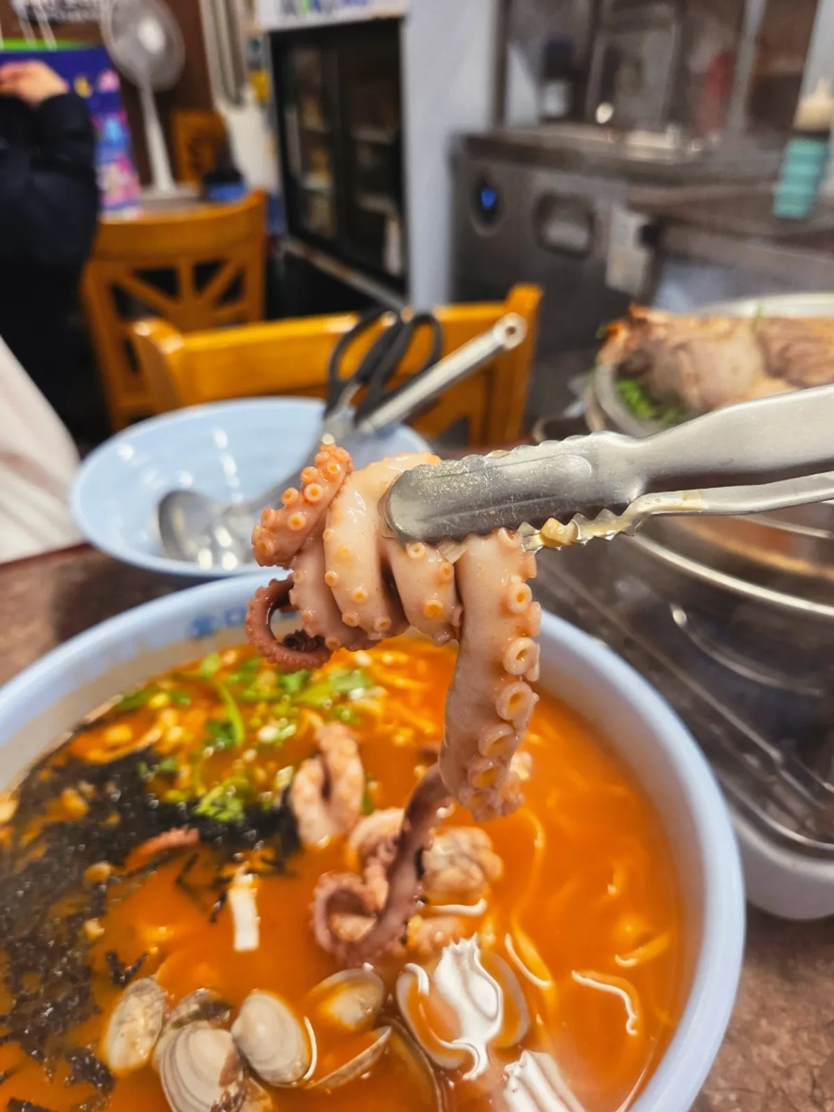 Pot of spicy octopus kalguksu with a fiery broth