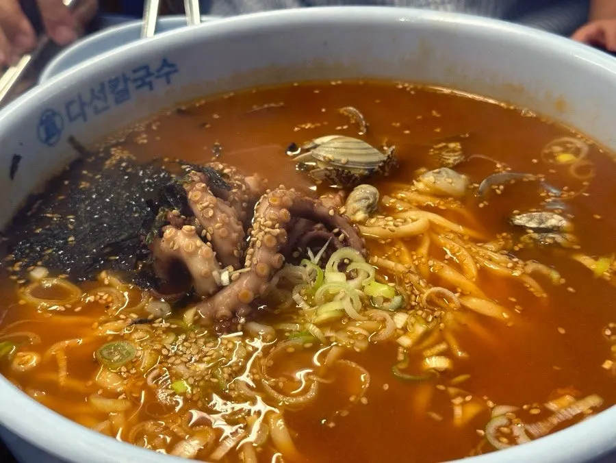 A spoonful of the spicy kalnakji broth