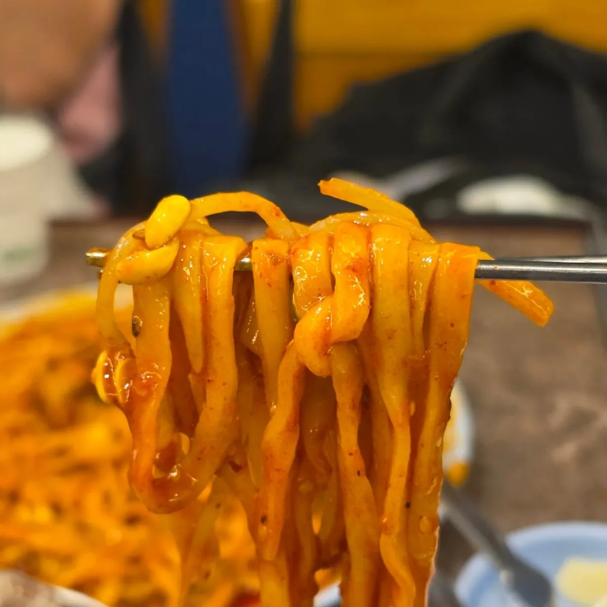 Knife-cut noodles mixed into the leftover spicy octopus sauce
