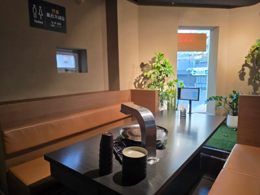 Ochre walls and soft lighting inside the Sodangkkae O-gyeopjip dining room