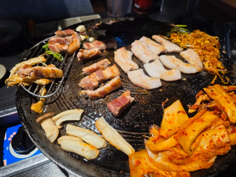 Pork turning golden brown on the cauldron lid