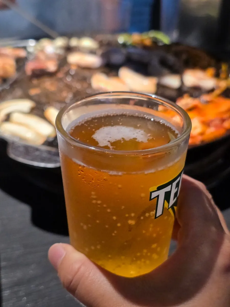 A glass of beer served alongside the meat