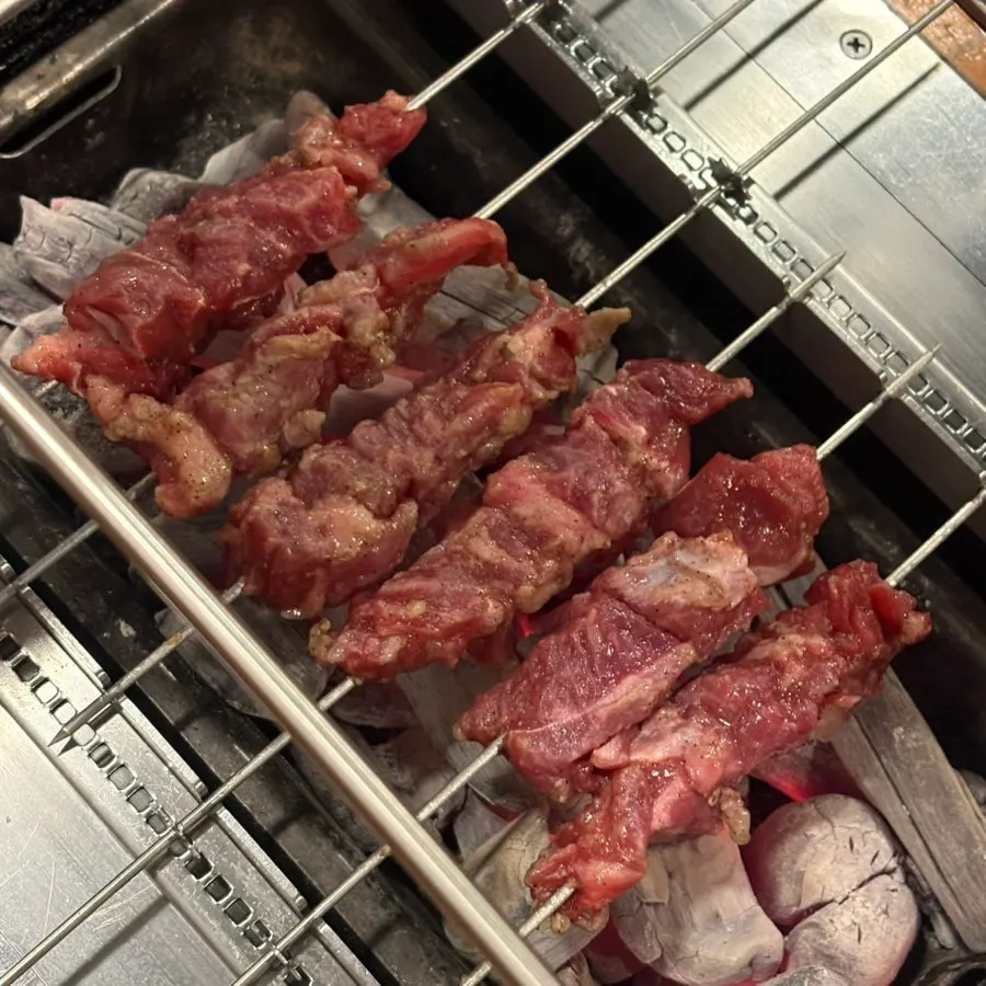 Lamb skewers grilling on the grill plate