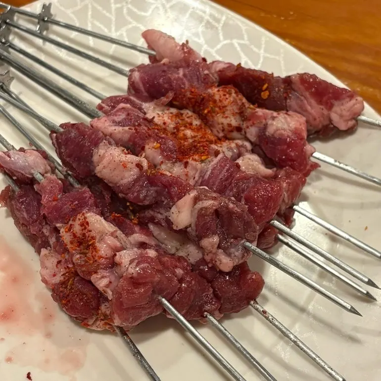 Beer glass and lamb skewer table spread