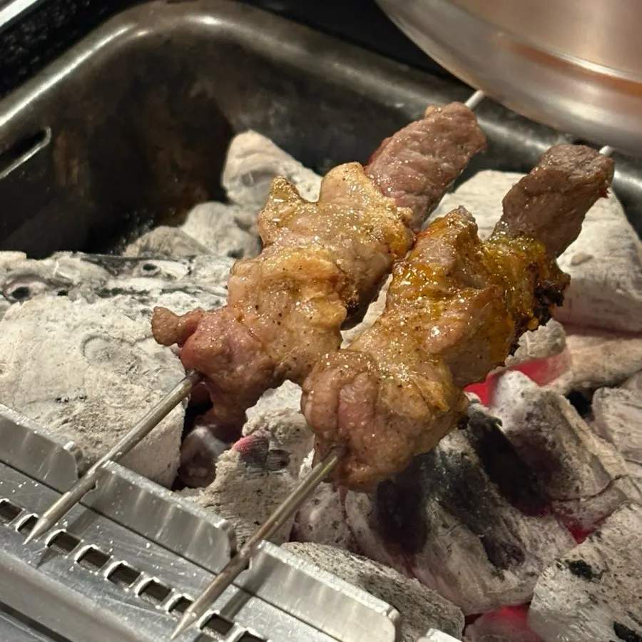 The last lamb skewer being grilled