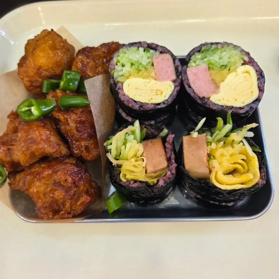 Black rice gimbap with cucumber strips and egg omelet