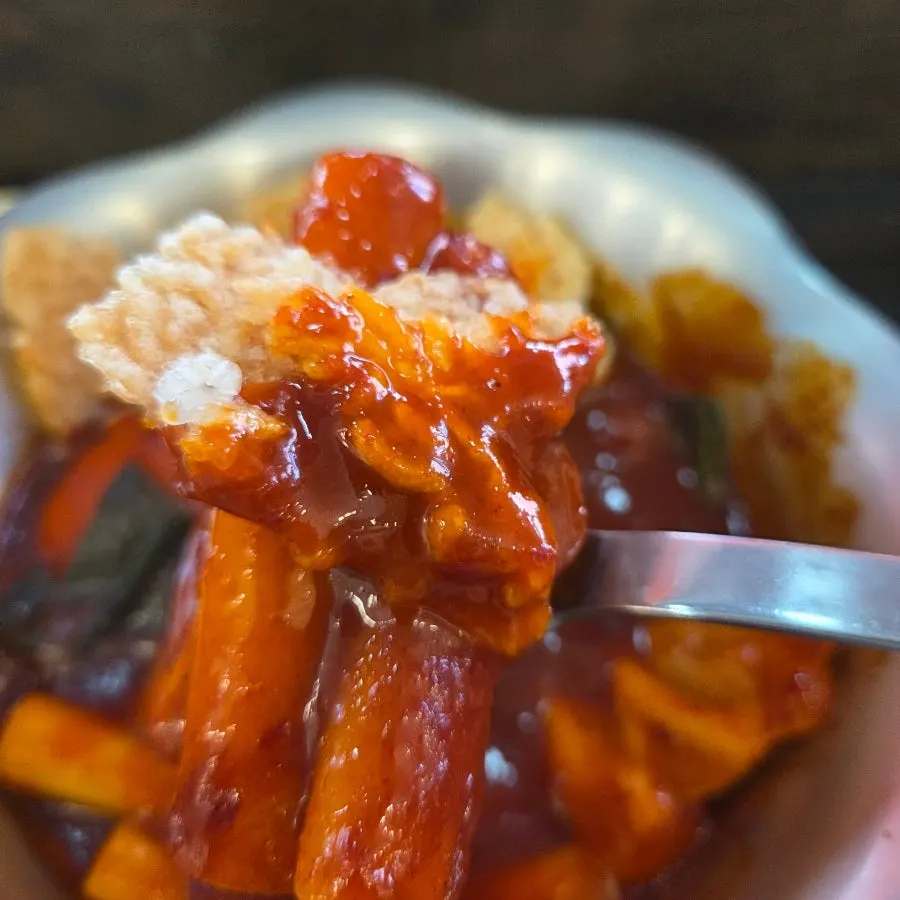 Plate of dakgangjeong topped with cheongyang chili and gimbap