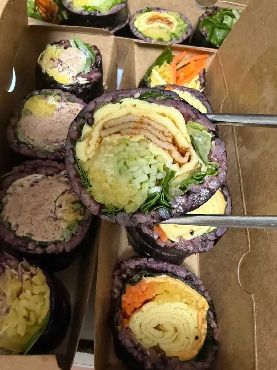 A plate of gimbap made with tuna and scallion