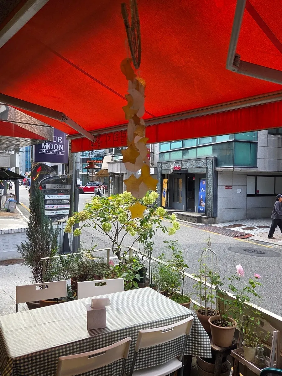 Terrace seating at Halls Gimbap Main Branch with plants