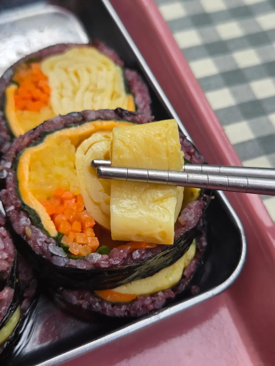 Double-cheese egg gimbap dipped in sauce