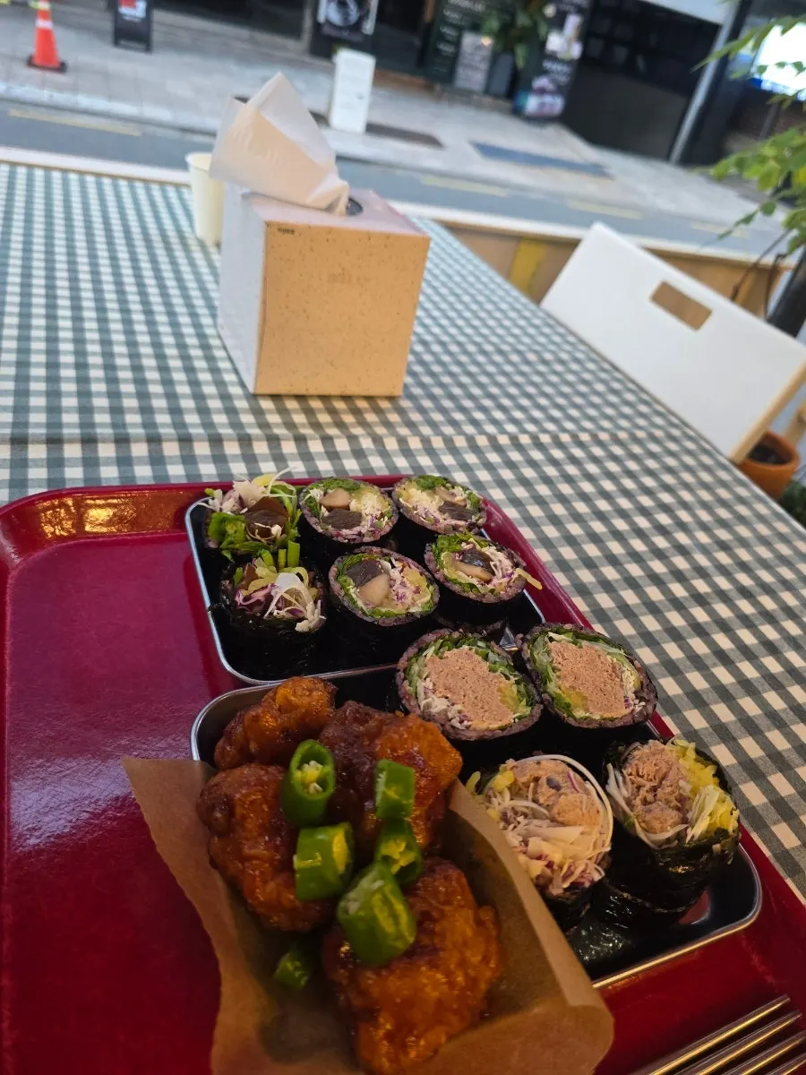 Picking up a piece of Jindo Green Onion Tuna Gimbap
