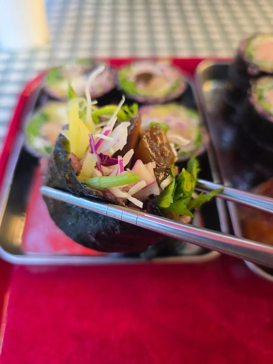Close-up of a piece of Konjac Water-Parsley Gimbap