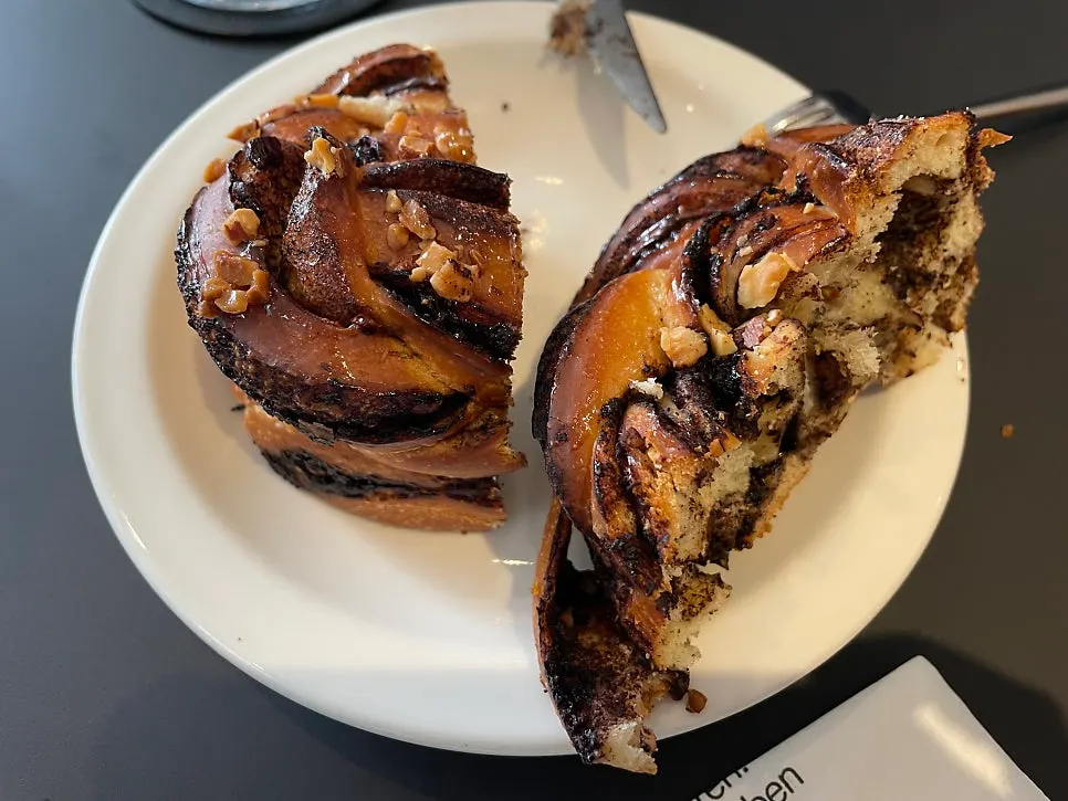 Babka split open showing chocolate and nuts inside