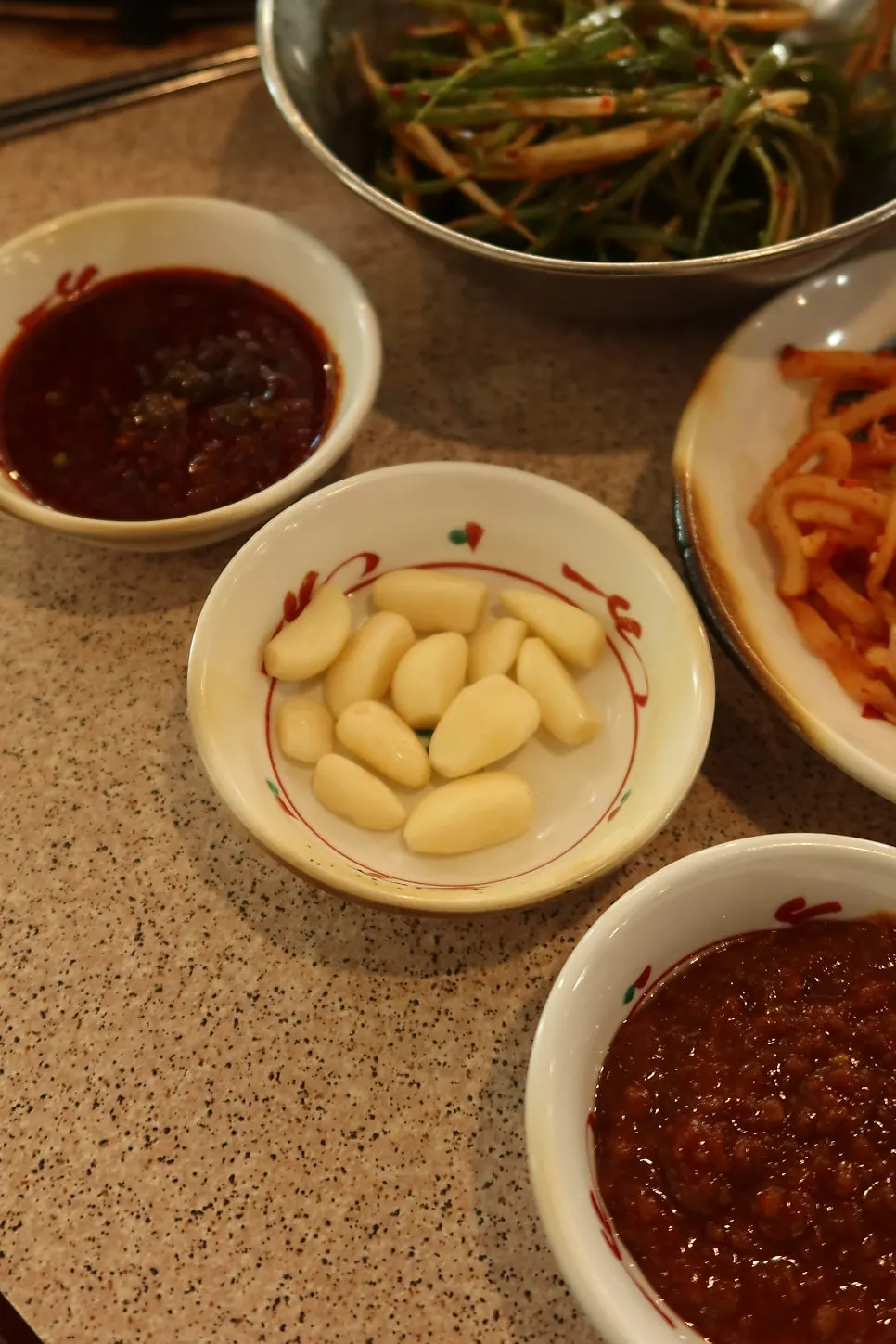 Plate of aged kimchi and other side dishes at Gyodaepae