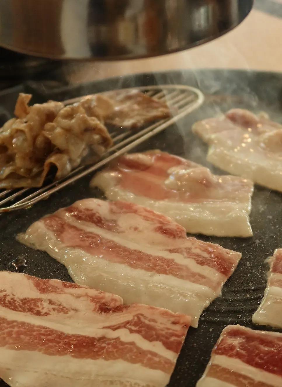 Meat cooking on the grill at Gyodaepae