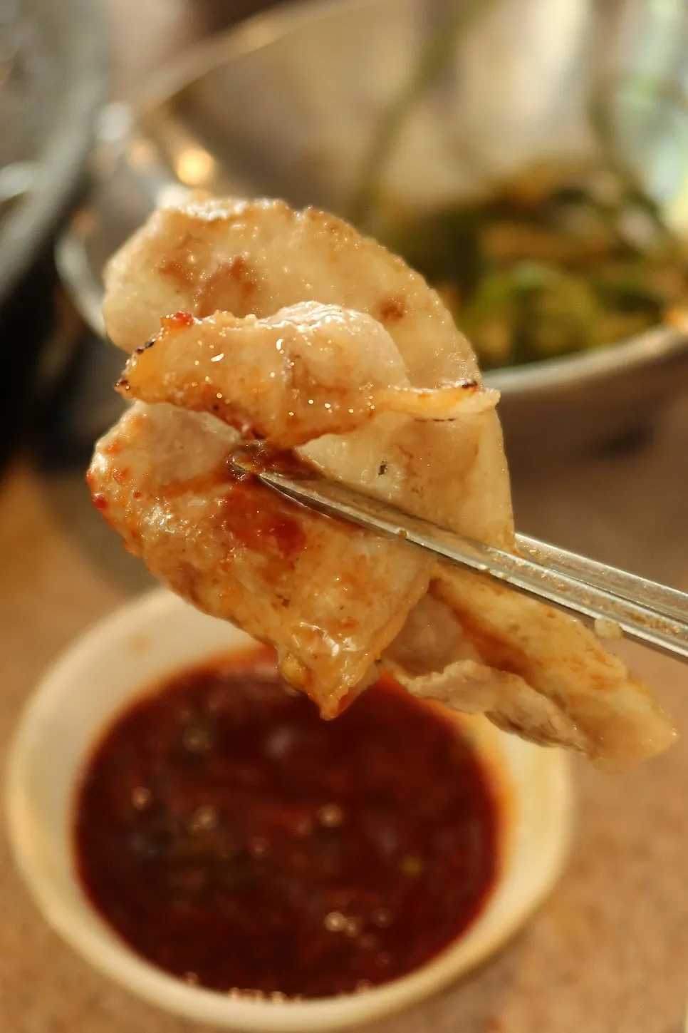 Frozen thin-sliced pork belly dipped in Gyodaepae's homemade special sauce