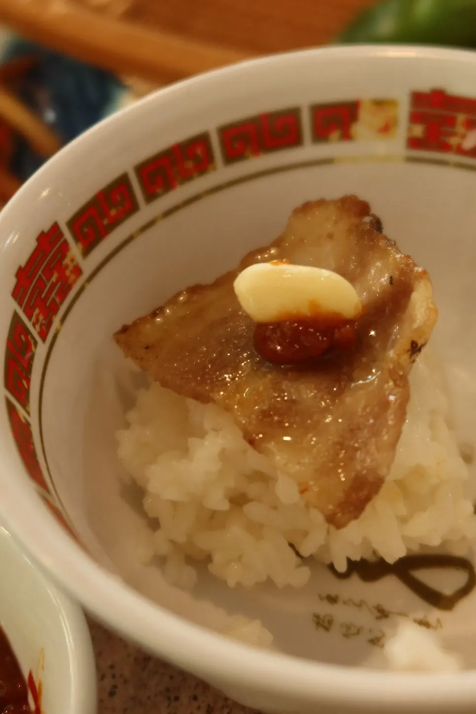 A piece of thin-sliced pork belly with the special sauce