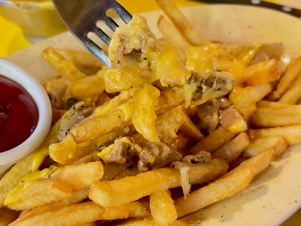 Fries with sautéed onions and bacon